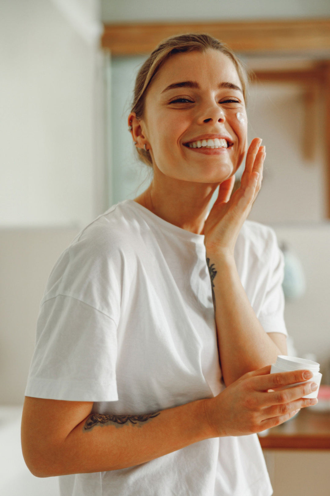 24H moisturizing and protective cream applied to a woman's face